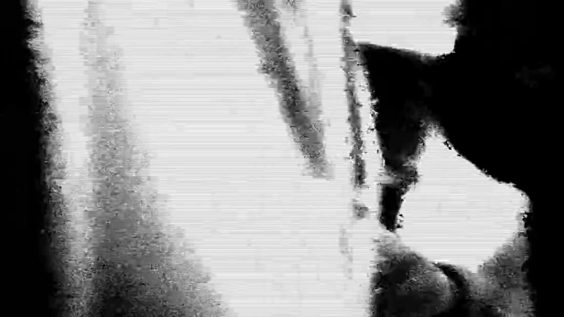 A head in profile against a lit wall, still from the Cosmos film